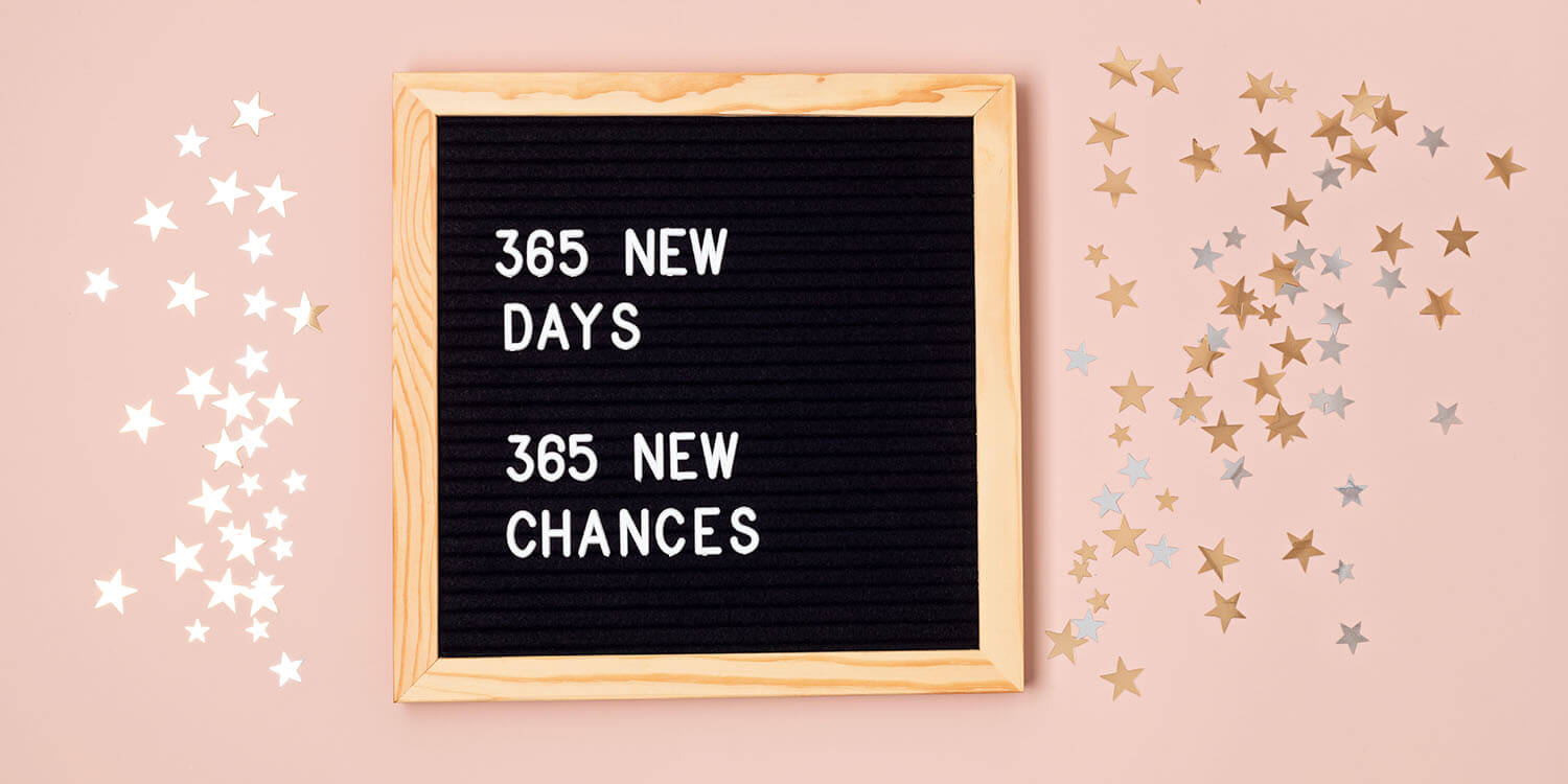 365 new days, 365 new chances. Letter board with new year motivational quote on pink background.