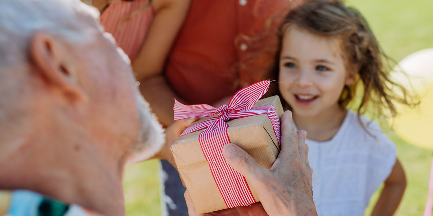 Happy little girl receiving present